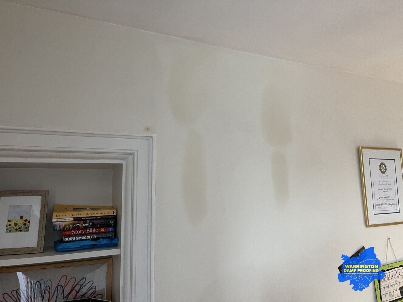 Penetrating damp water staining near a ceiling corner